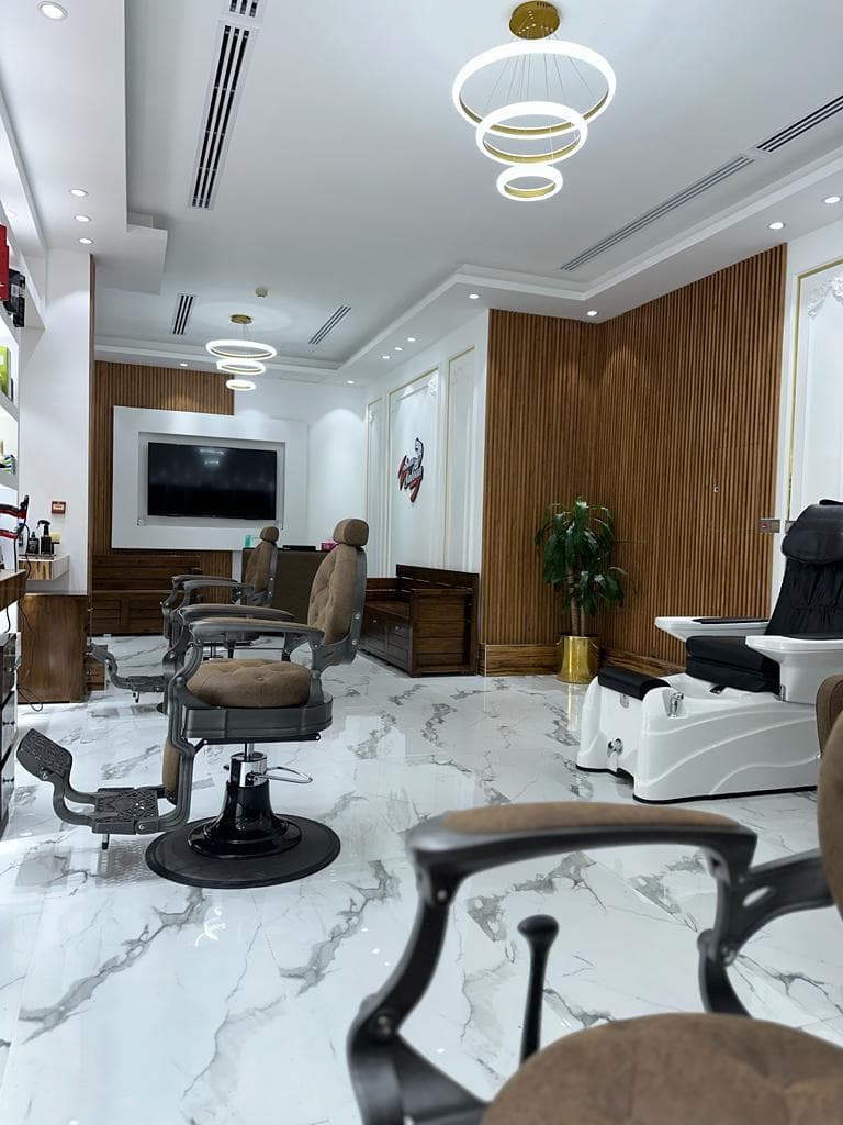 Zohan Saloon styling and pedicure lounge with marble floor and gold ring lighting